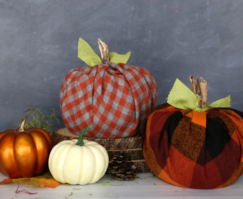 Pumpkin made from a roll of toilet paper wrapped with flannel fabric with a stick for the stem and ribbon tied around for leaves