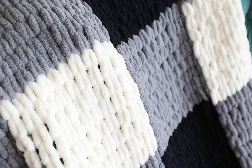 A close up of a finger knit blanket