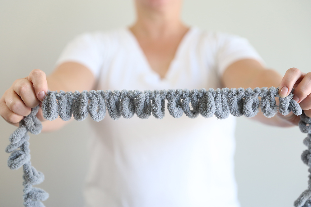 Person holding strand of loop yarn