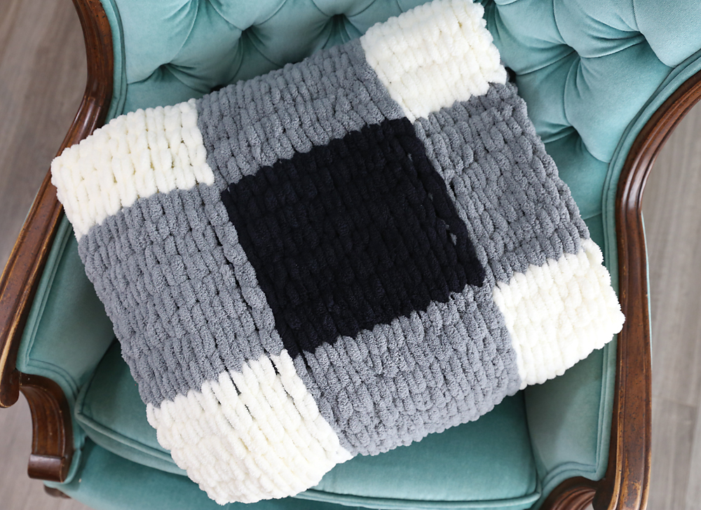 Loop yarn blanket folded on a chair