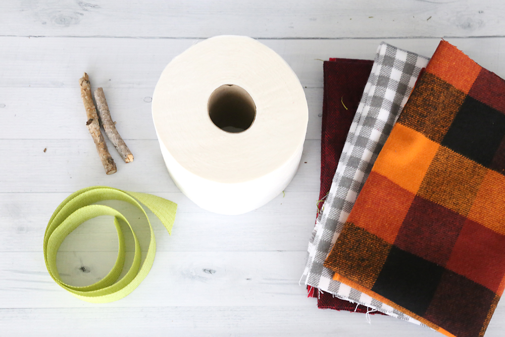 Toilet paper pumpkin supplies: stick, ribbon, toilet paper, plaid flannel fabric