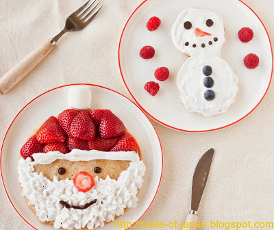 Plates with pancakes shaped like Santa and snowmen