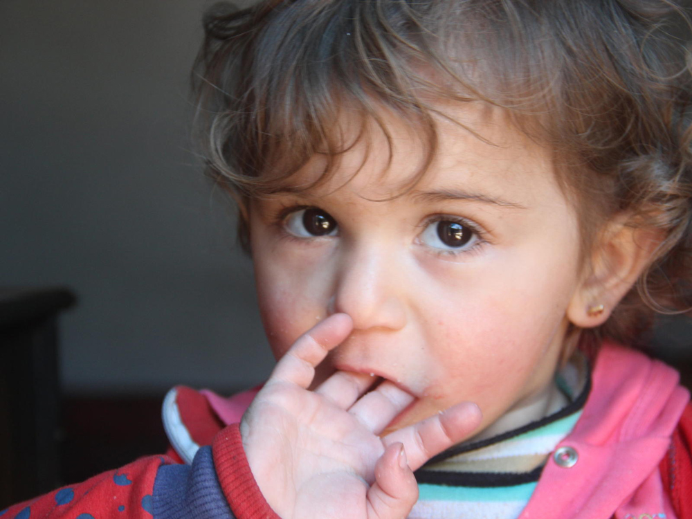 A little girl in a blue shirt