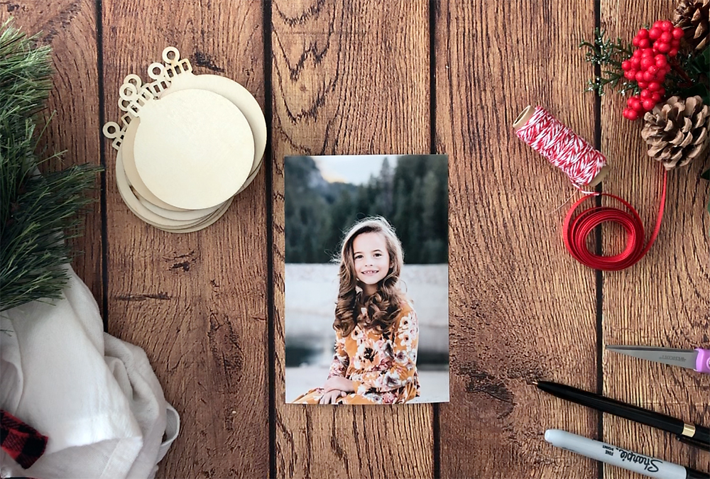 Unfinished wood ornaments, photo of a girl, twine, ribbon