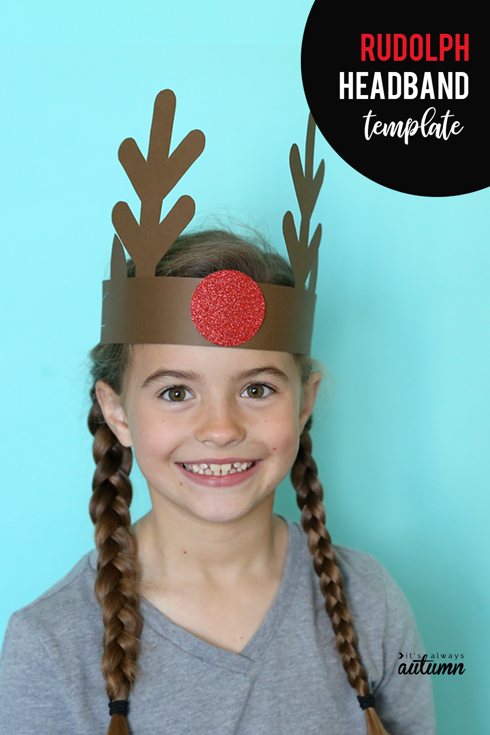 Girl wearing a reindeer headband made from brown and red paper