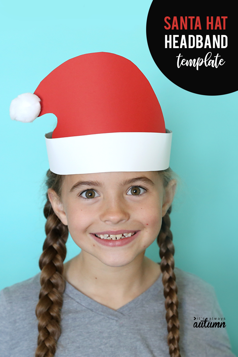 A girl wearing a Santa hat headband made from paper