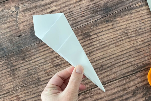 Paper folded again to make narrower triangle