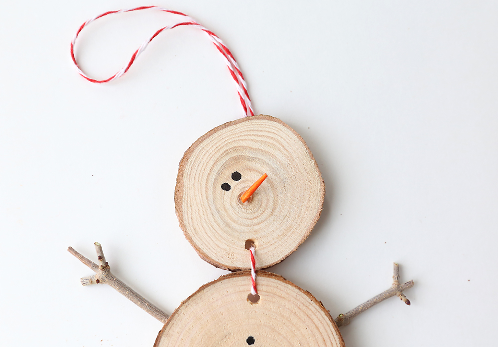 End of toothpick glued onto the snowman ornament for a nose