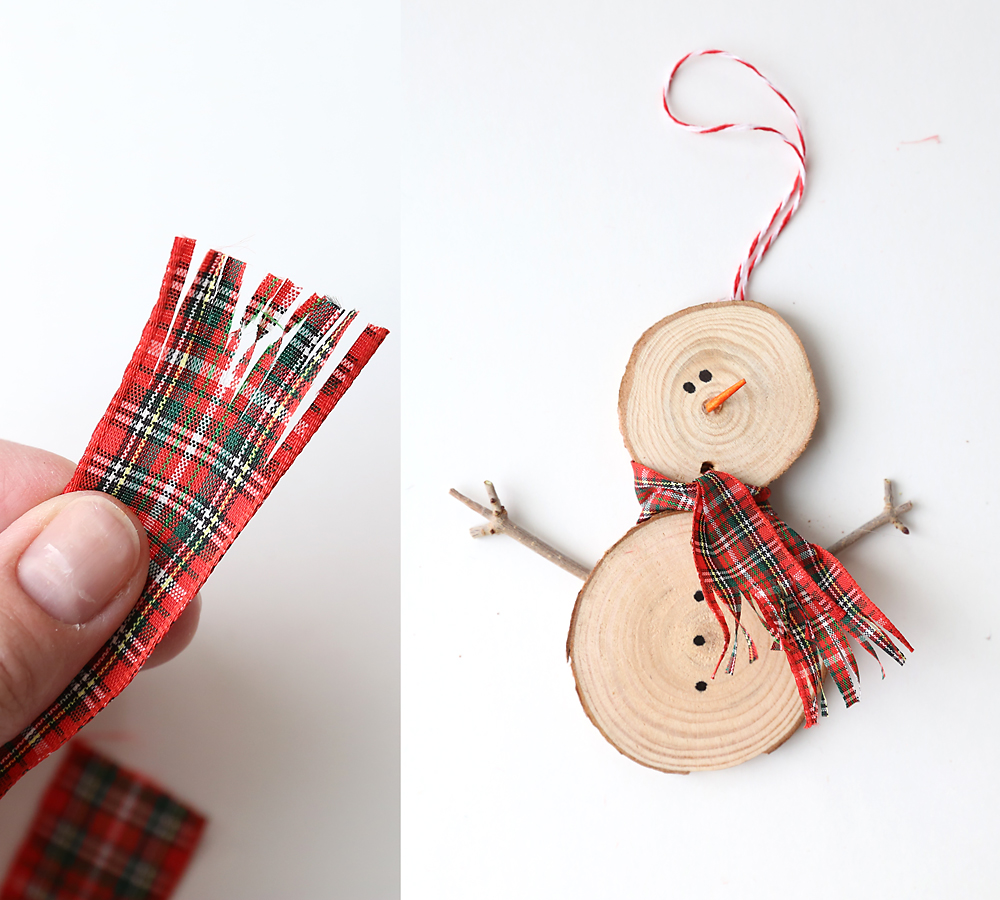 Piece of ribbon with ends fringed tied between the two wood slices as a scarf