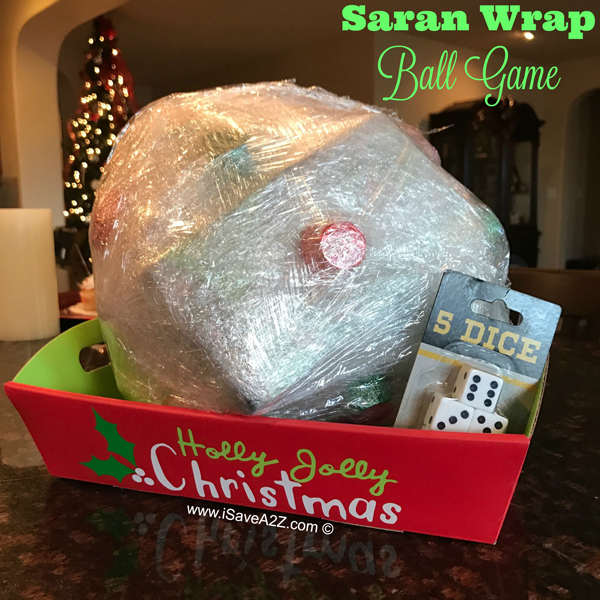 Small toys wrapped into large saran wrap ball Christmas game