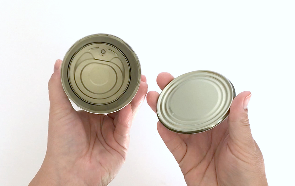 A pop top can with the bottom removed and inside cleaned out