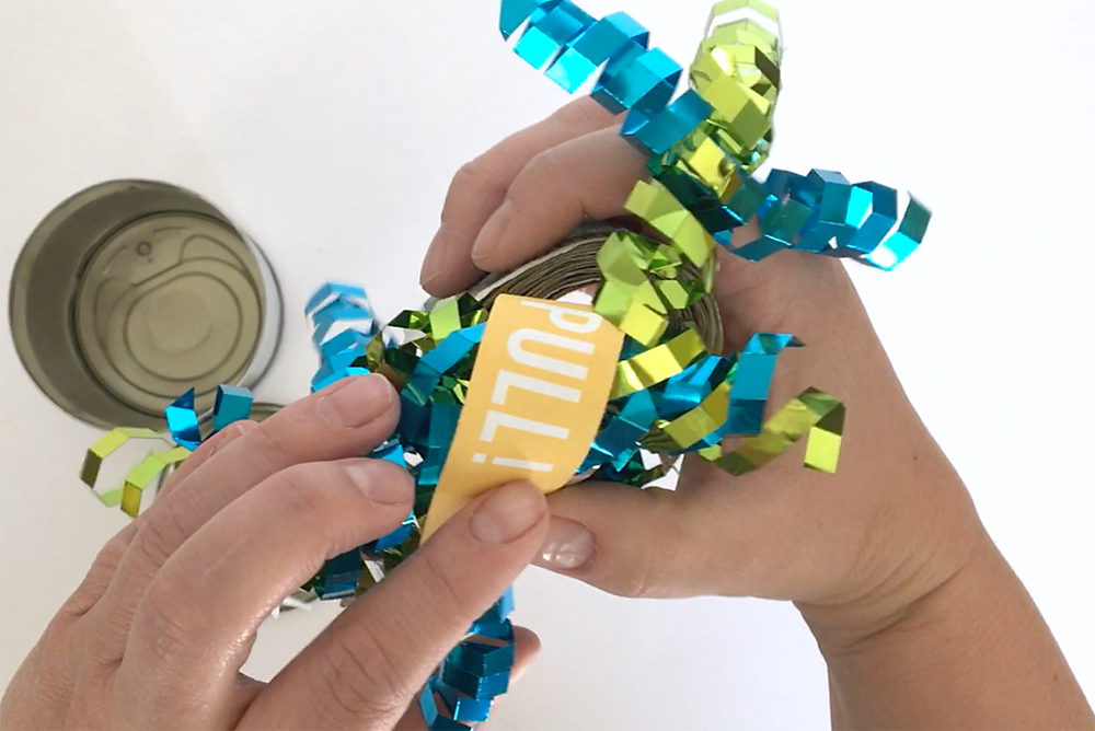 Hands holding roll of money with ribbon on top