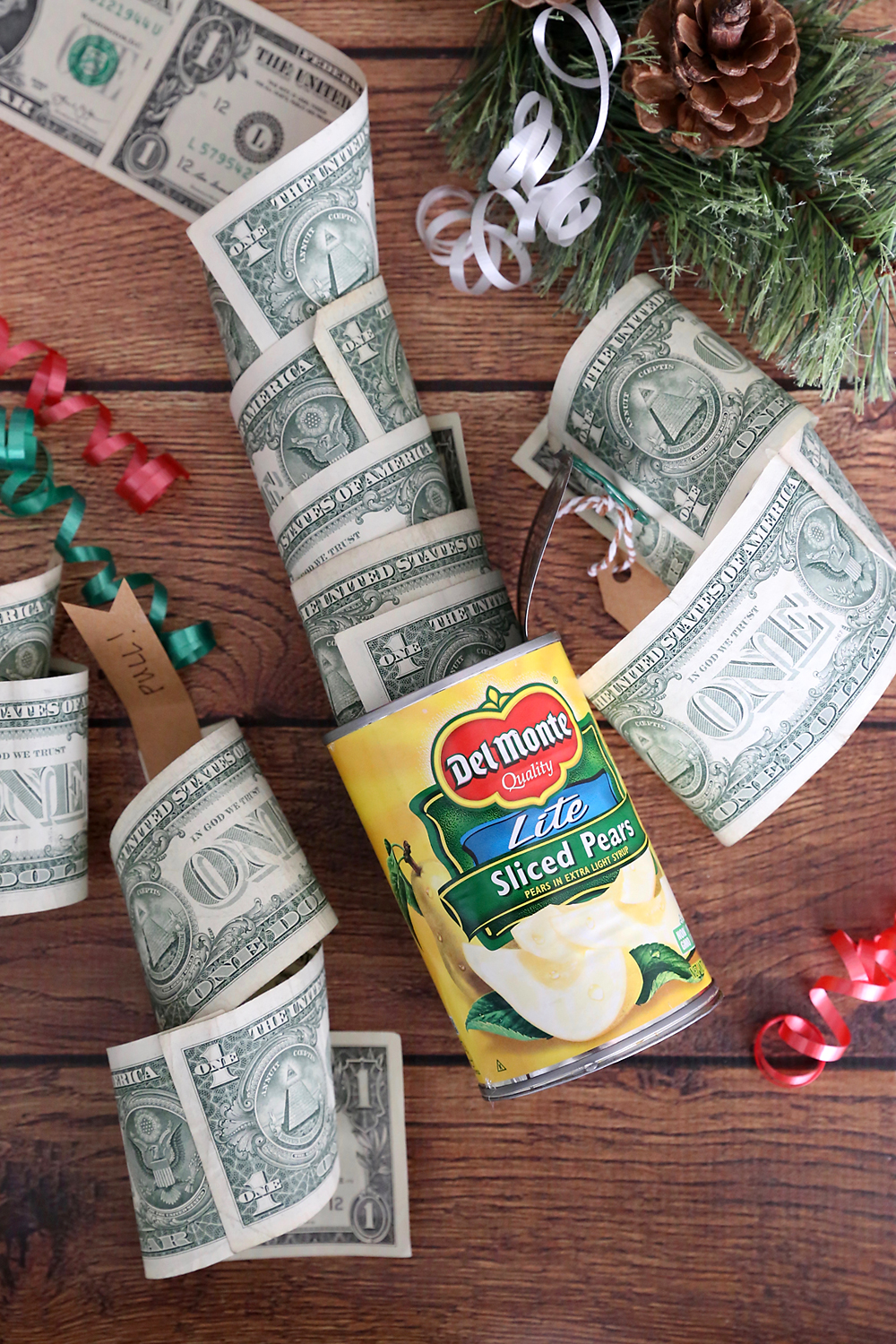 Roll of one dollar bills inside a can of pears