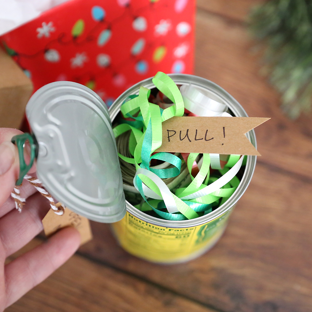 Pop top can of peaches with the top open to show ribbons and a tag that says pull