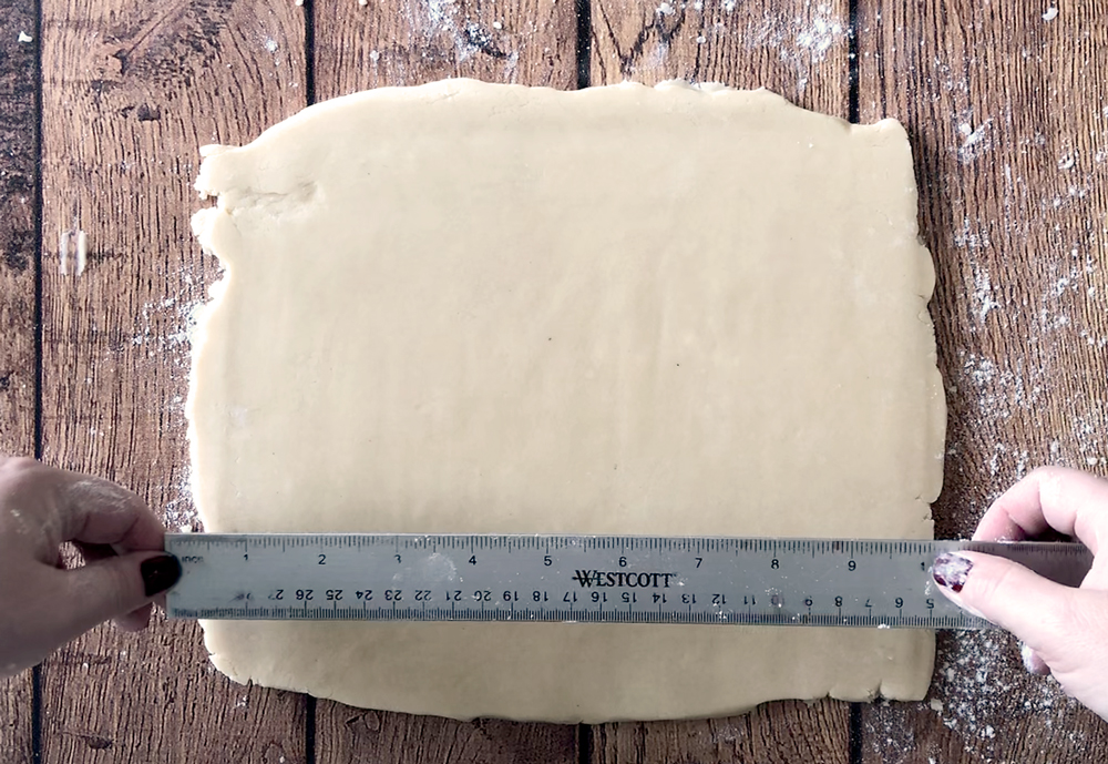 Shortbread dough rolled into a rectangle on a table