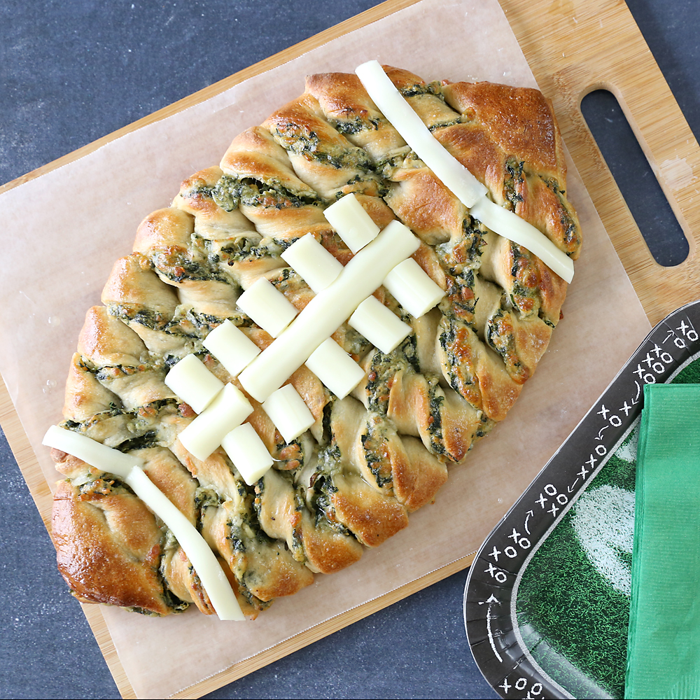 Spinach dip breadsticks in the shape of a football