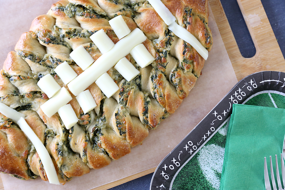 Spinach dip breadsticks in the shape of a football