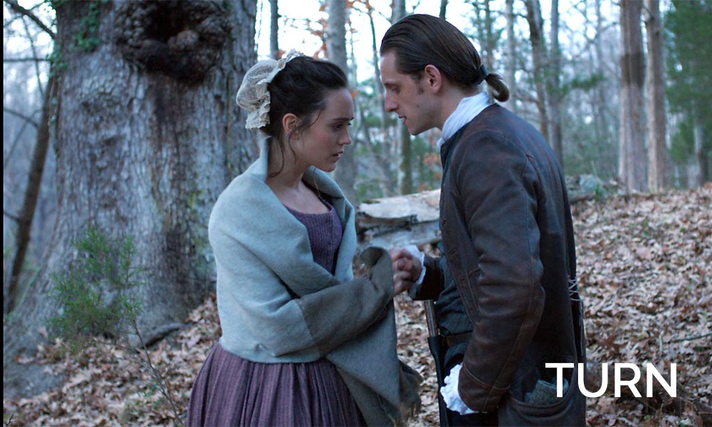 A man standing next to a woman in Revolutionary War times in the show Turn