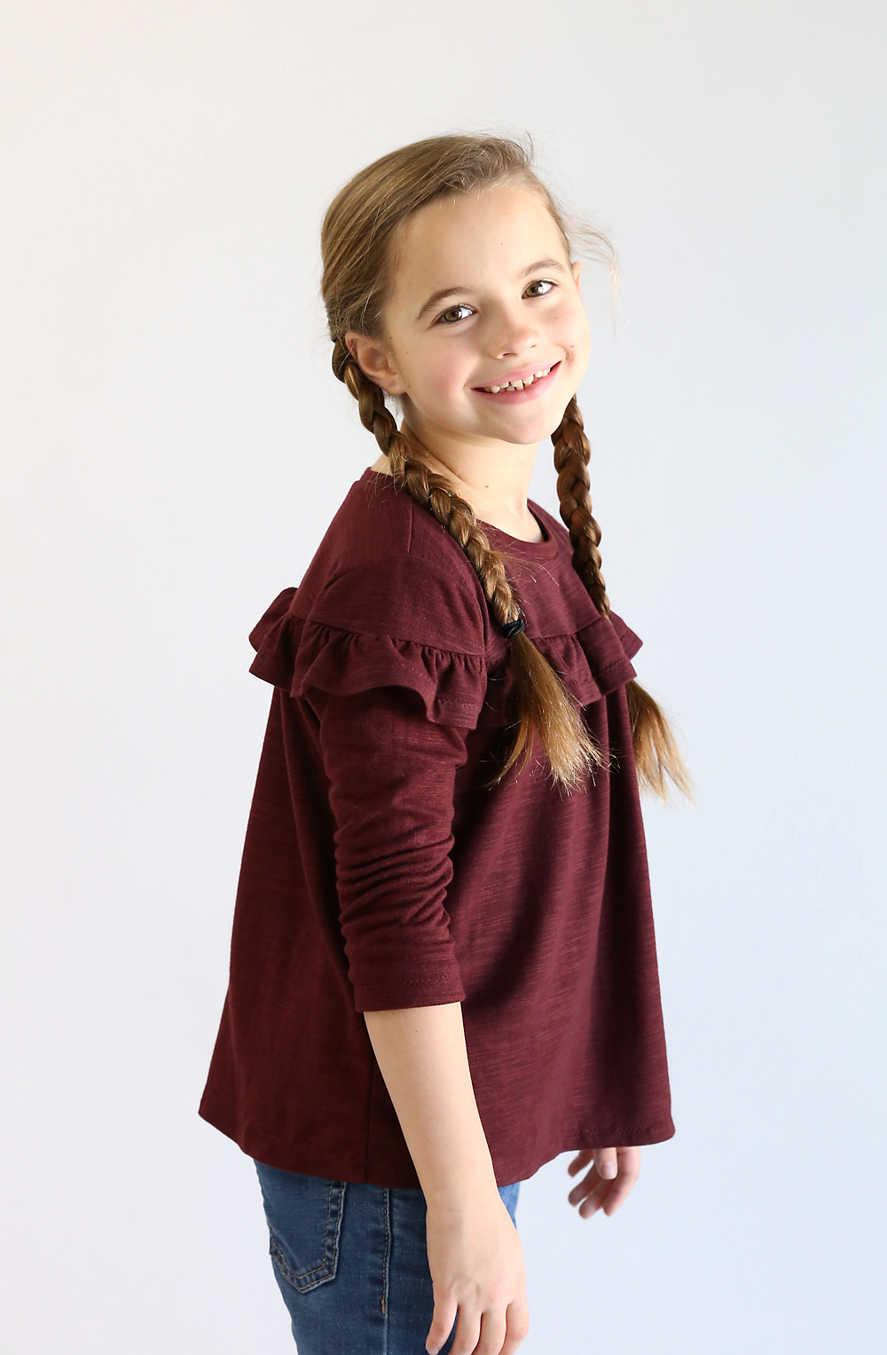 Girl wearing ruffled t-shirt made from free sewing pattern