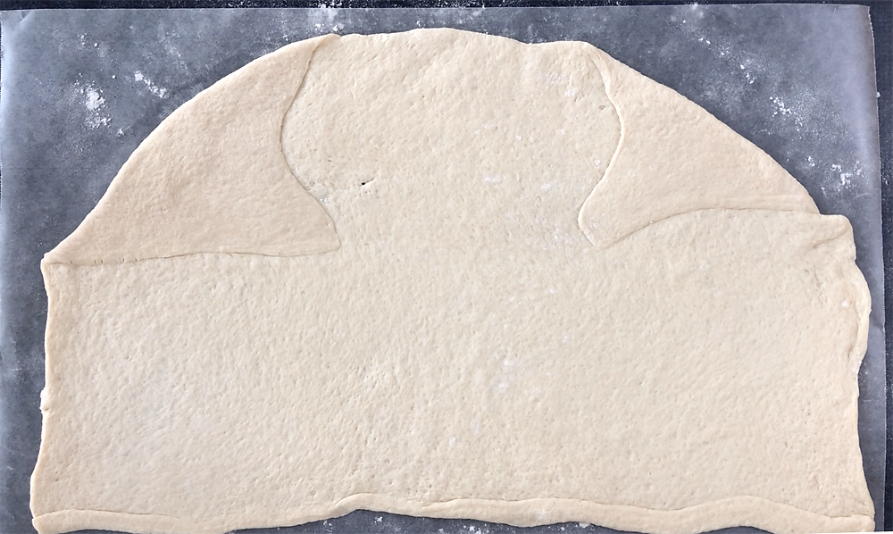 Pizza dough on wax paper