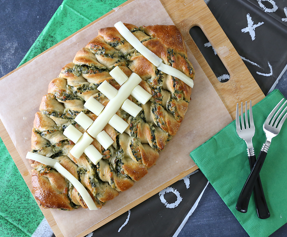 Spinach dip breadsticks in the shape of a football