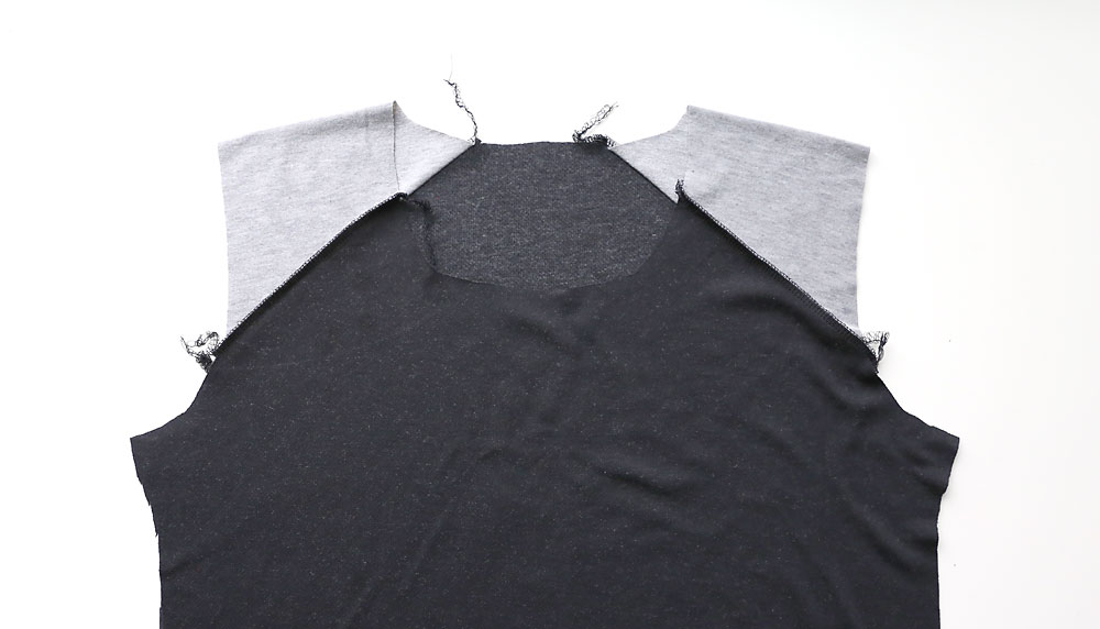 Shirt with shoulder pieces sewn to front and back