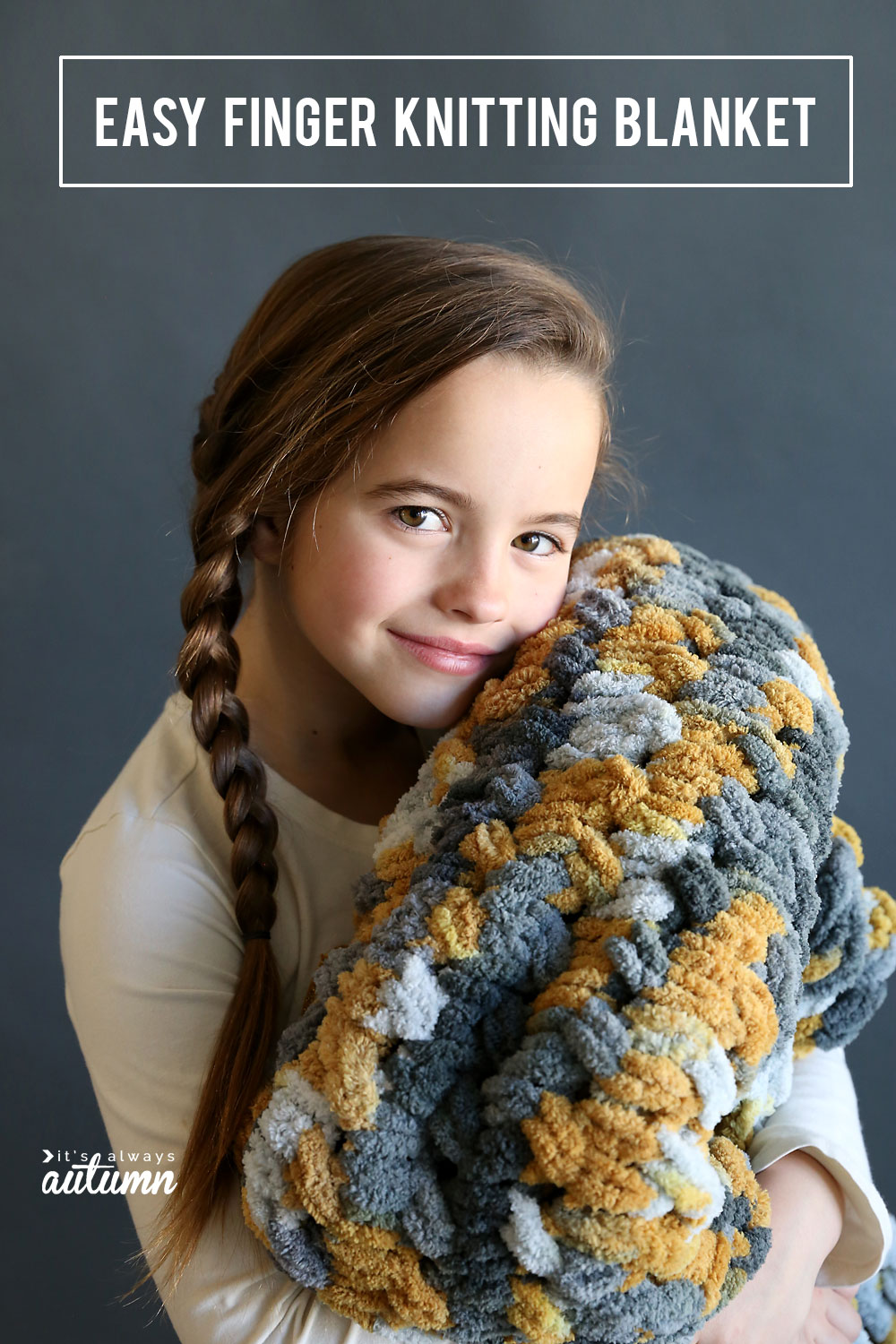 Girl holding a grey and yellow loop yarn blanket