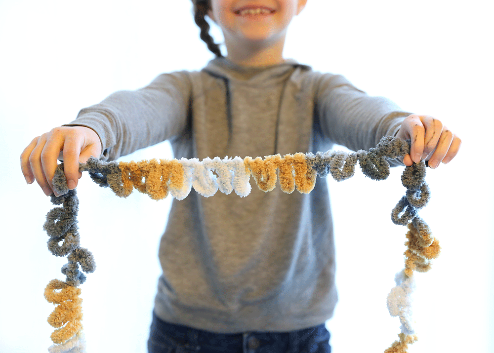 Girl holding a length of loop yarn
