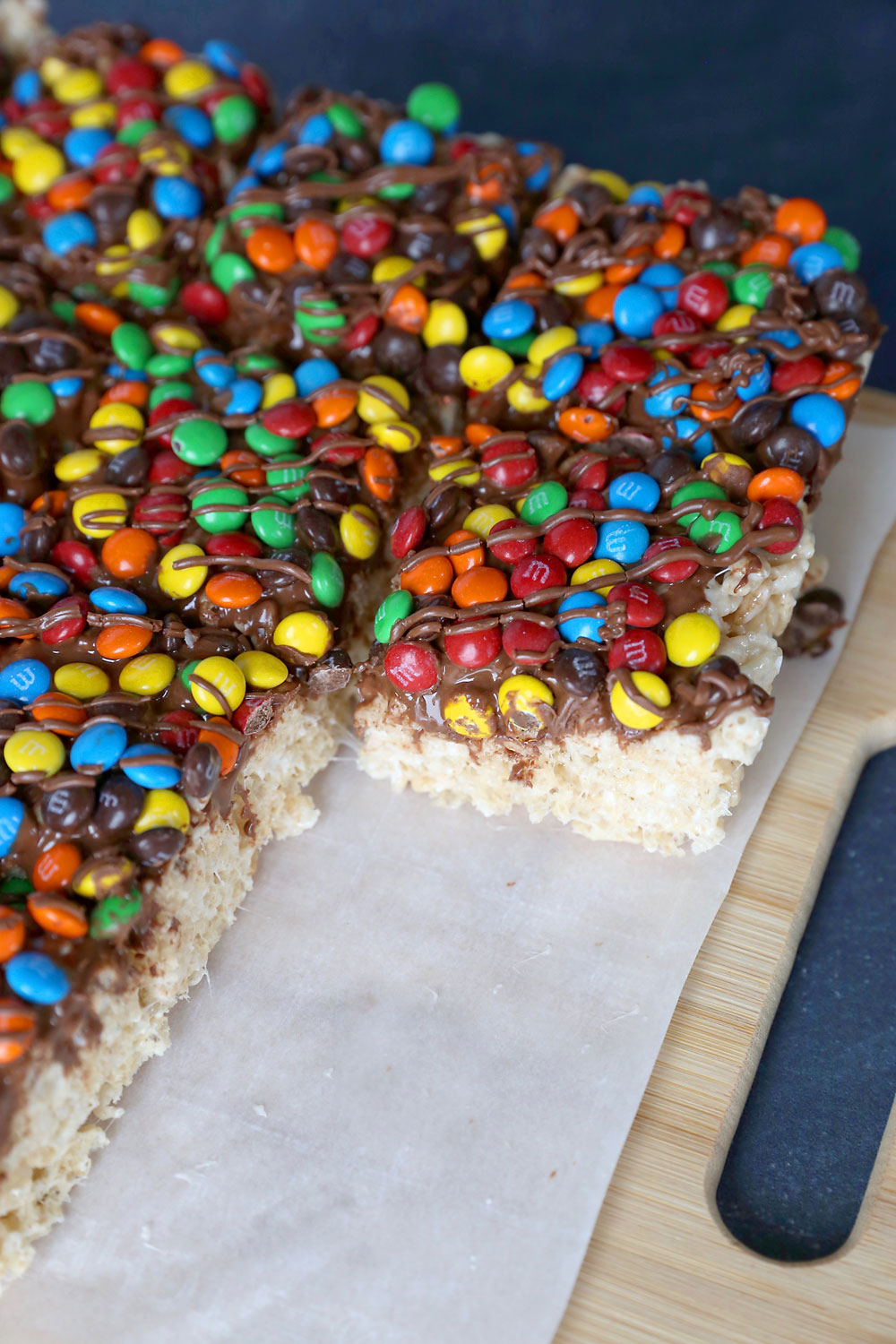 Rice Krispie treats covered in mini M&Ms and chocolate