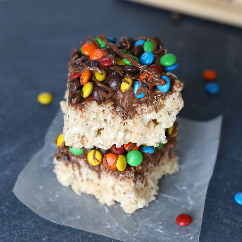Rice Krispie treats covered in mini M&Ms and chocolate