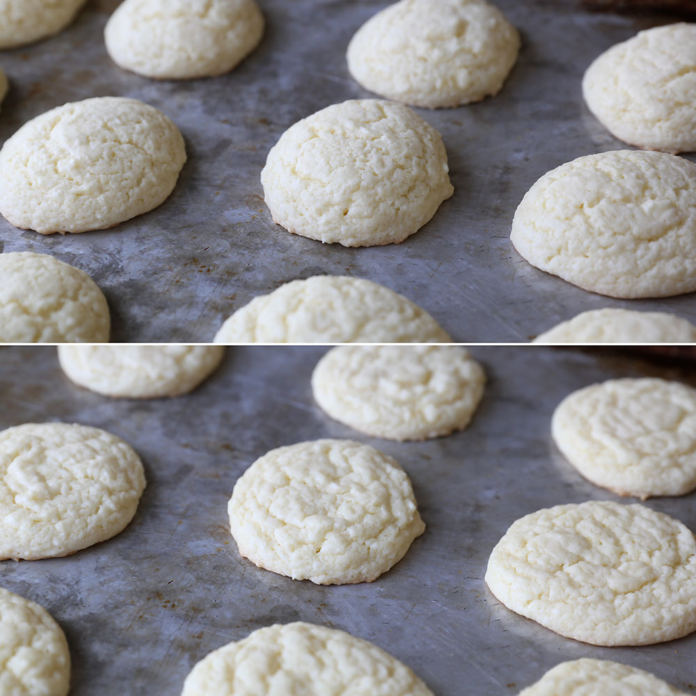 Baked cookies on a cookie sheet, puffed up and then slightly flattened