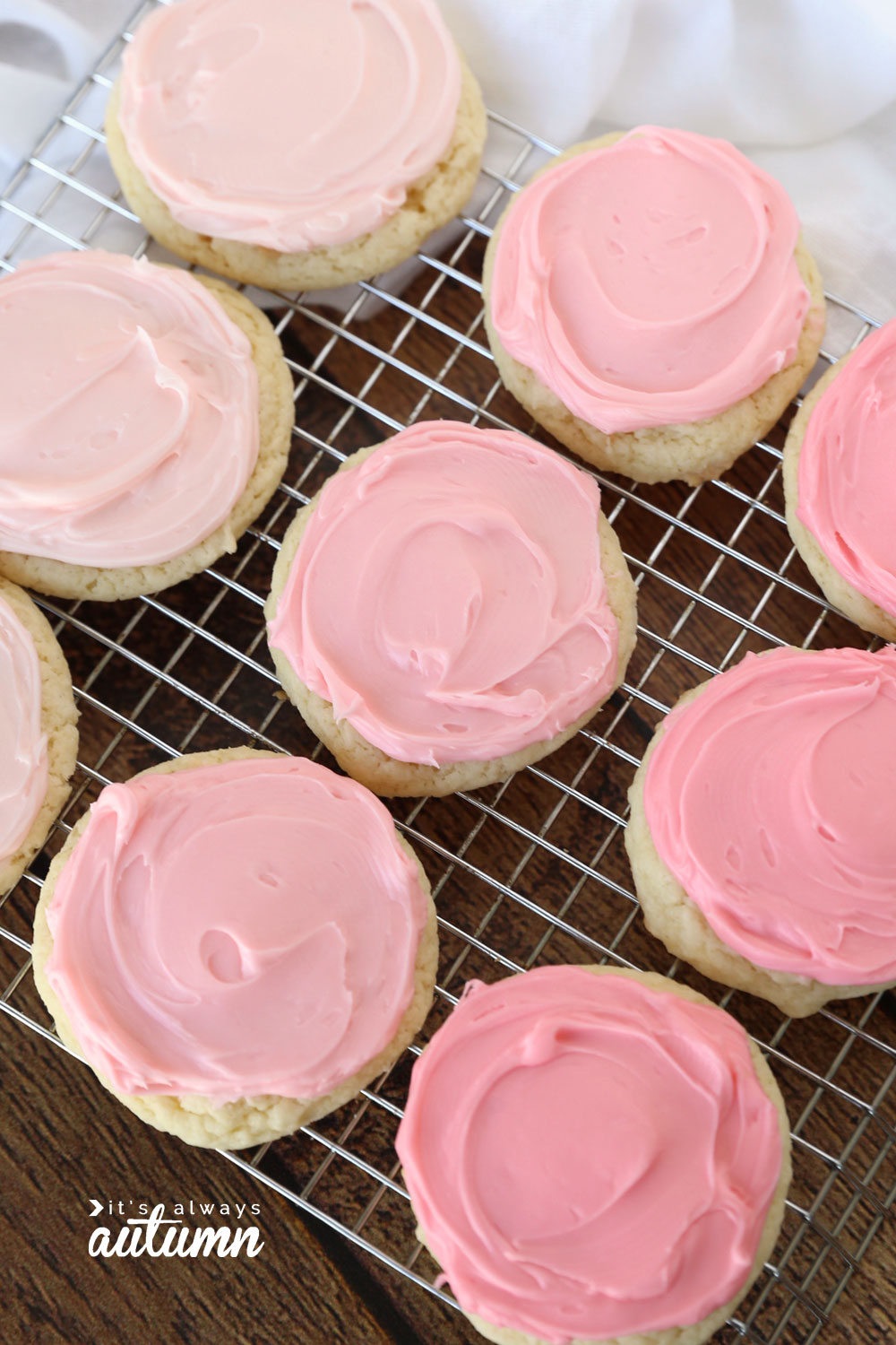 Cake mix sugar cookies with pink frosting on a cooling rack