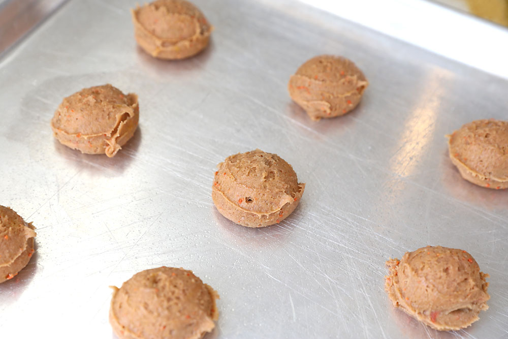 Carrot cake cookie dough balls on a cookie sheet