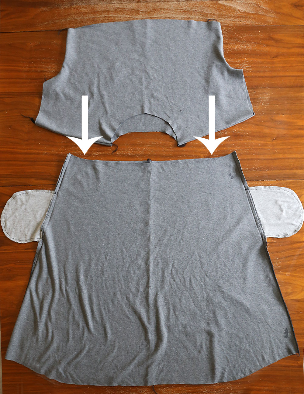 Bodice upside down with arrows showing it slides inside the skirt 