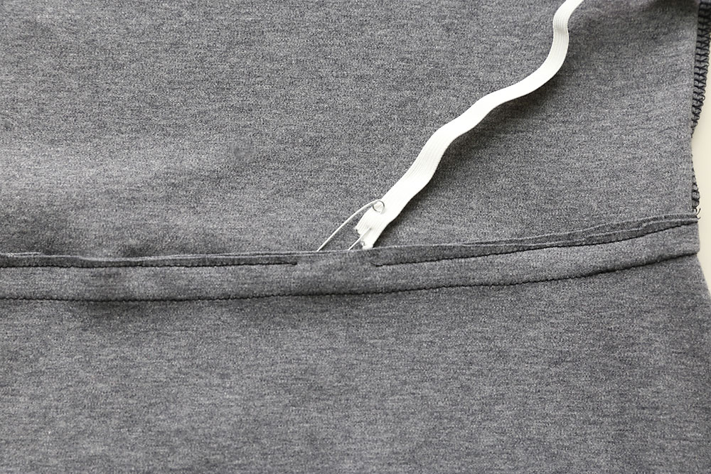 Strip of elastic being thread into the casing with a safety pin