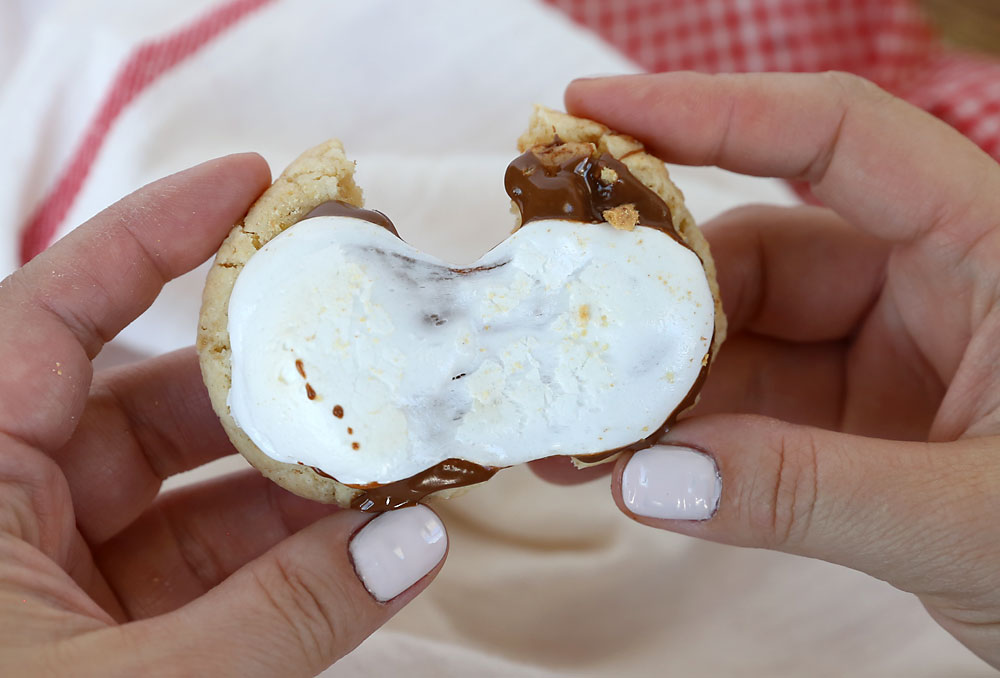 Hands breaking a s\'mores cookie in half