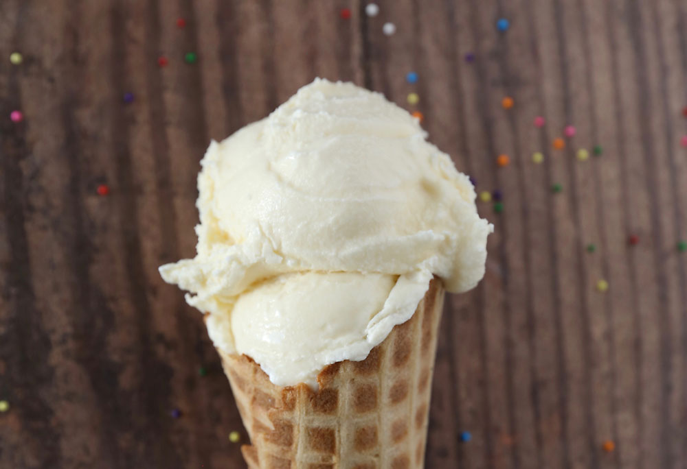 Scoop of homemade vanilla ice cream in a cone