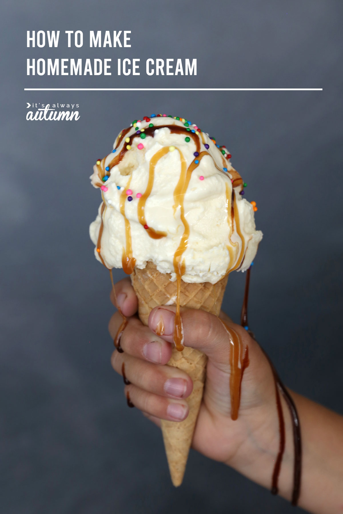 Hand holding a vanilla ice cream cone with chocolate and caramel syrup and sprinkles