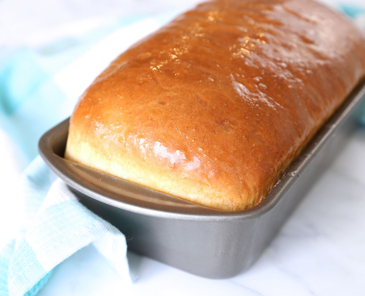 Loaf of homemade white bread in a loaf pan