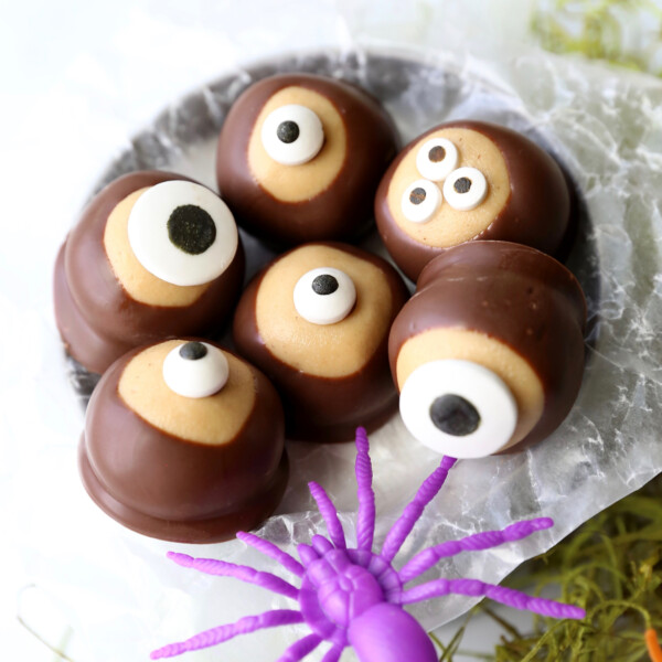 Peanut butter balls dipped in chocolate and topped with candy eyes