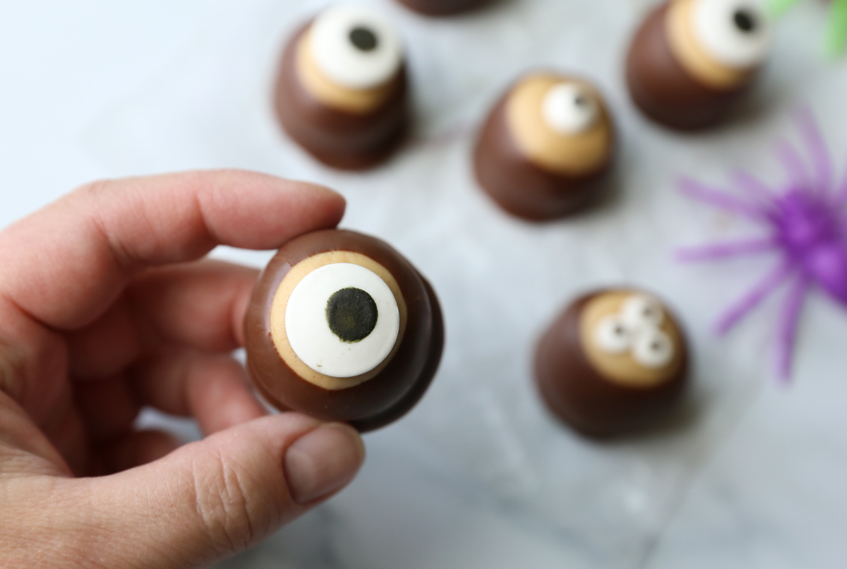 Peanut butter balls dipped in chocolate and topped with candy eyes