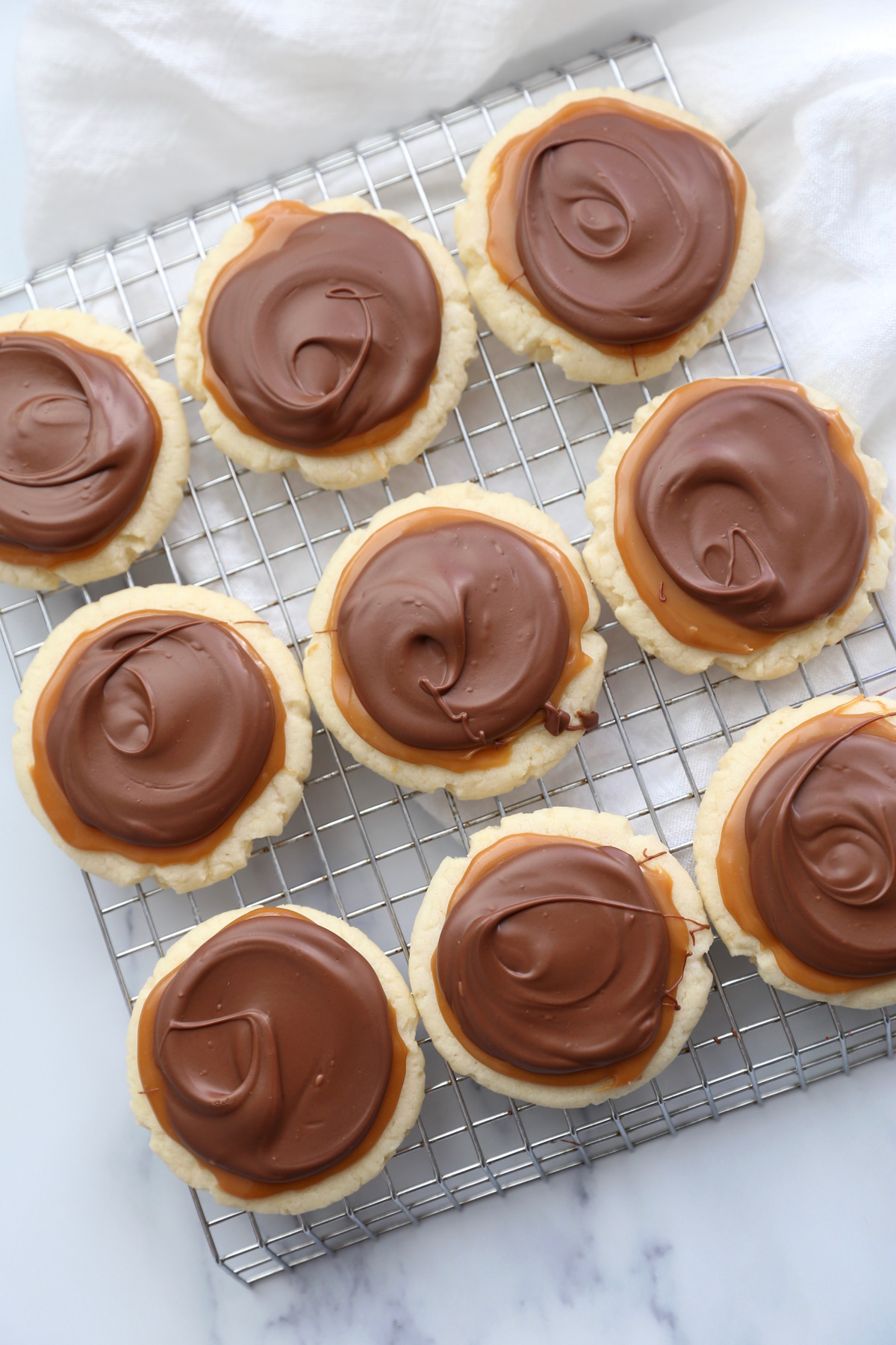 Rows of twix cake mix cookies on a cooling rack 