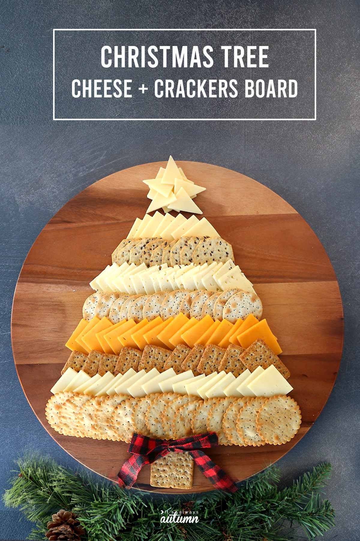 Cheese and crackers in the shape of a Christmas tree on a wood tray