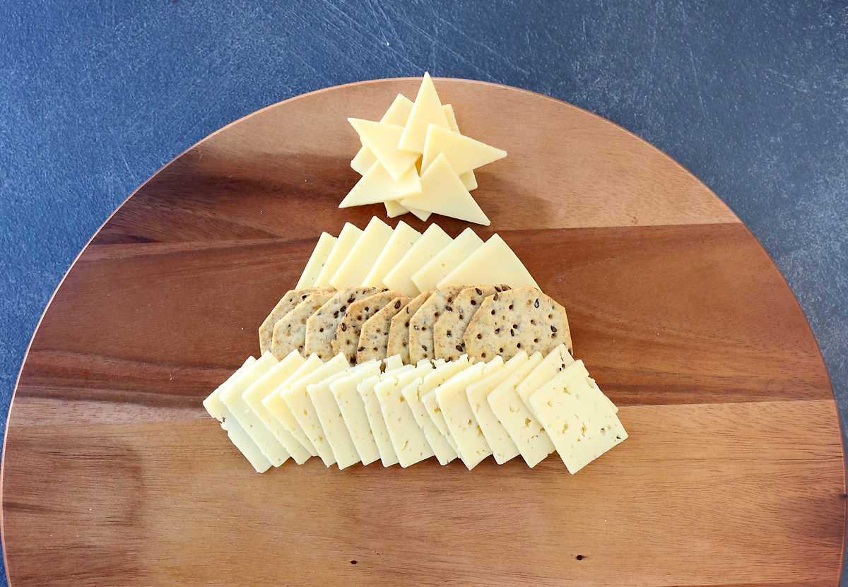 Cheese star with short row of cheese slices, then wider row of crackers, then another row of cheese slices