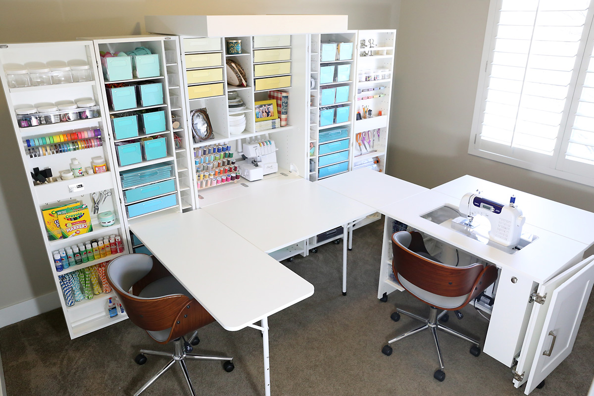 A craft organization system with a desk and multiple bins to hold supplies