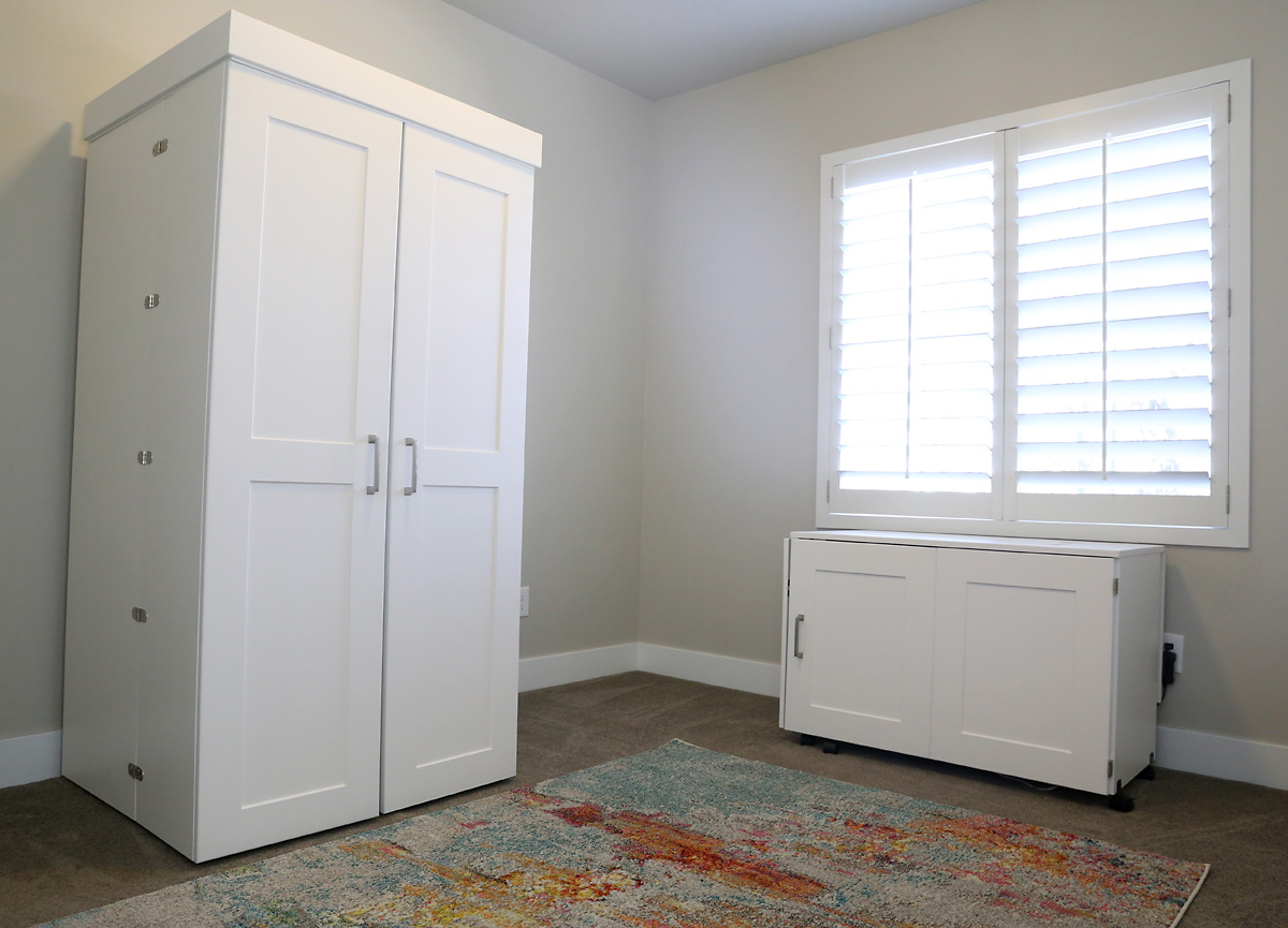 DreamBox and Sew Station closed up into white cabinets