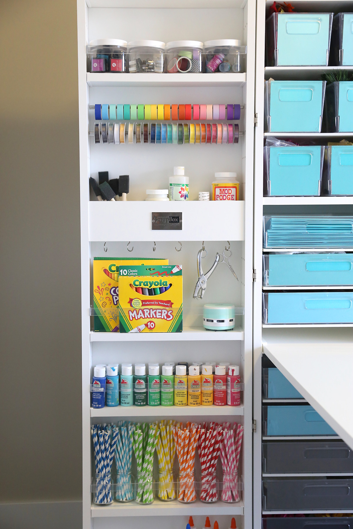 A close up of one door of a DreamBox holding various colored craft supplies