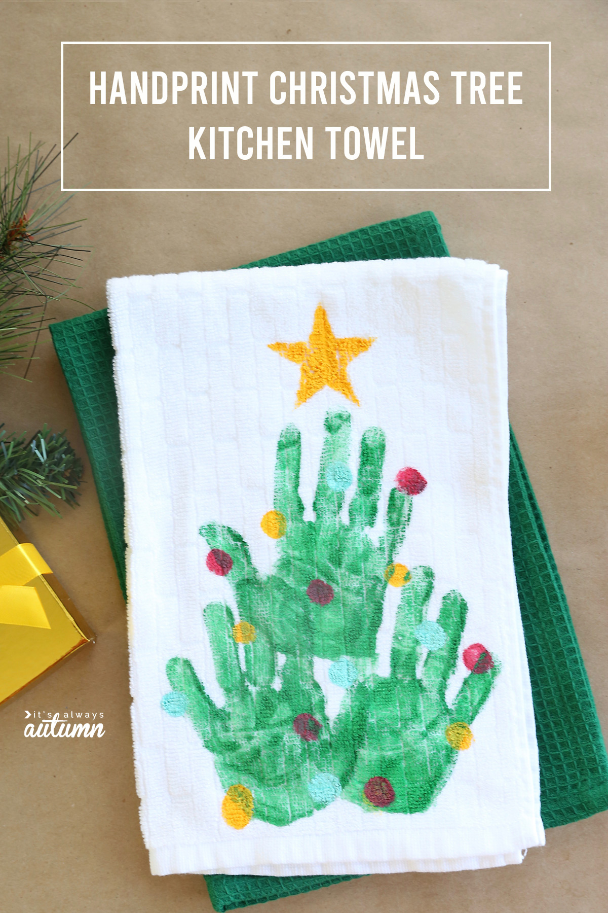 Cute idea! Make a handprint Christmas tree kitchen towel - fun homemade Christmas gift idea.