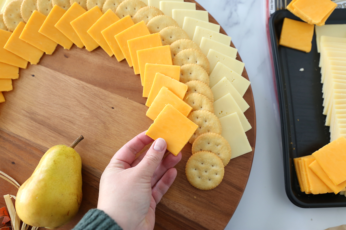 And adding rows of cheese slices and crackers, working in from the outside
