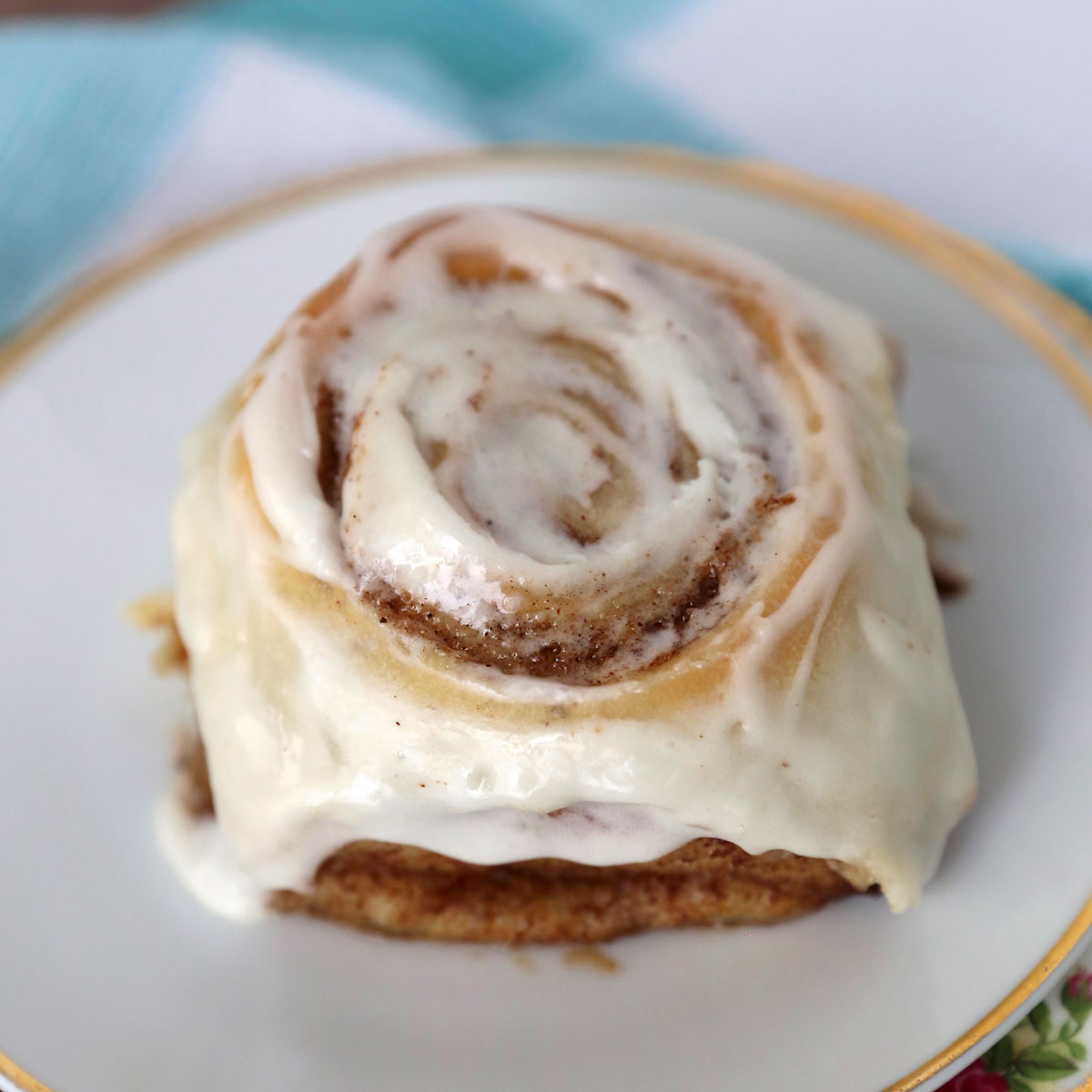 A cinnamon roll on a small plate